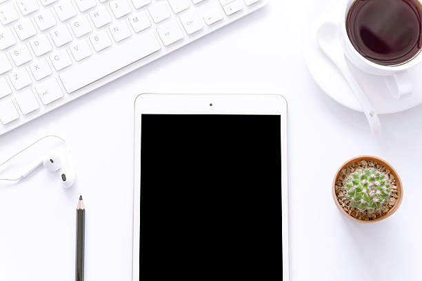 istock Office desk top view with smartphones, flower,coffee cup. 626145182