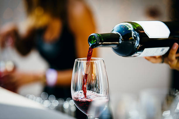 Pouring red wine. Man pouring red wine to wine glass.  wine stock pictures, royalty-free photos & images