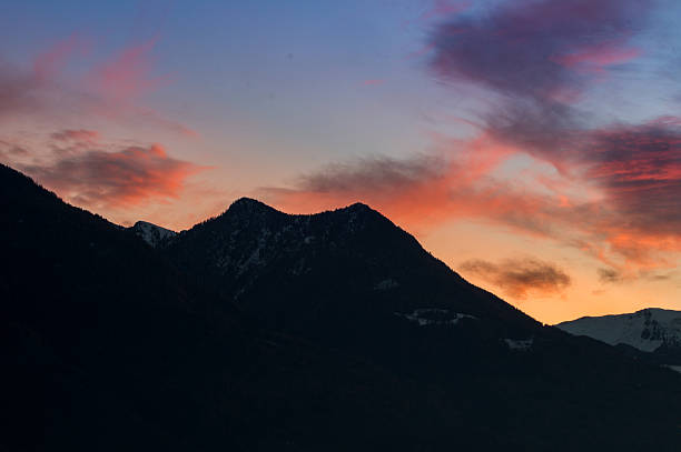 istock cloudy sunset, colorful red sky, sky adn mountains on background 626156494