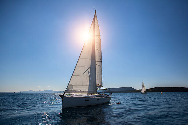 istock Luxury sailing ship yachts boat with white sails in Sea. 626157036