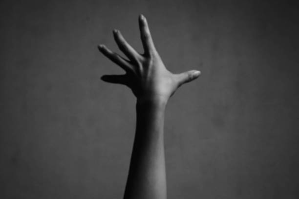 istock blurry photo of hand raising 626157310
