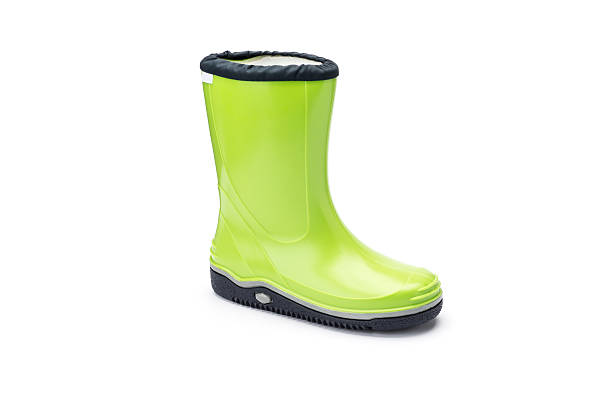Individual childs bright green wellington or rain boot shot at a 3/4 angle on a white background