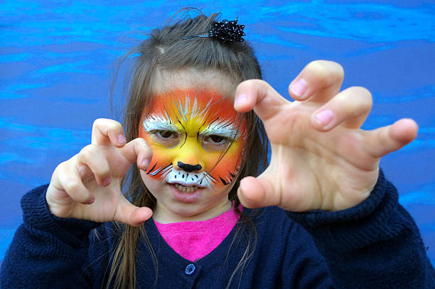 istock Little child with lion face painting 626172694