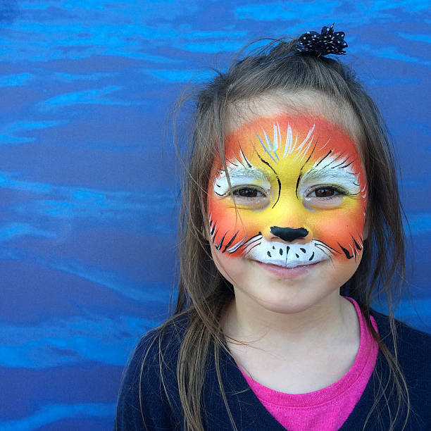 istock Little child with lion face painting 626172790