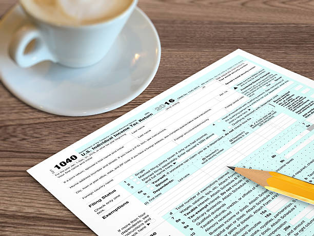 istock Tax form wooden desk top view 626173362