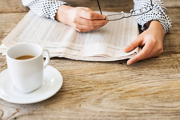 istock Reading newspaper on wooden table 626175780