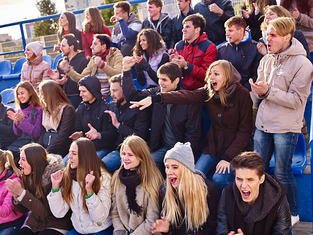 istock Sport fans clapping and singing on tribunes. 626176124