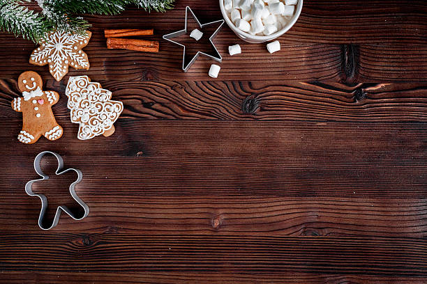 istock Christmas gingerbread, spruce branches on dark wooden background top view 626176420