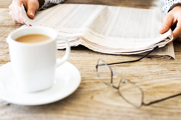 istock Reading newspaper on wooden table 626176594