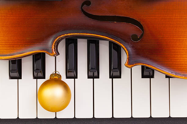 istock Piano keyboard,old violin and Christmas decoration 626177168