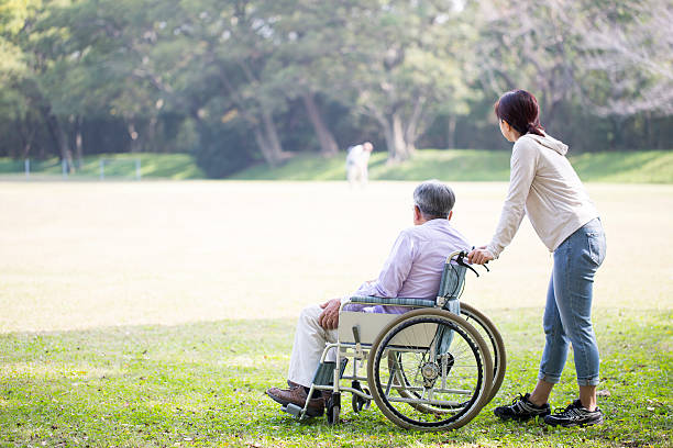 istock Wheelchair old man and helper 626177596