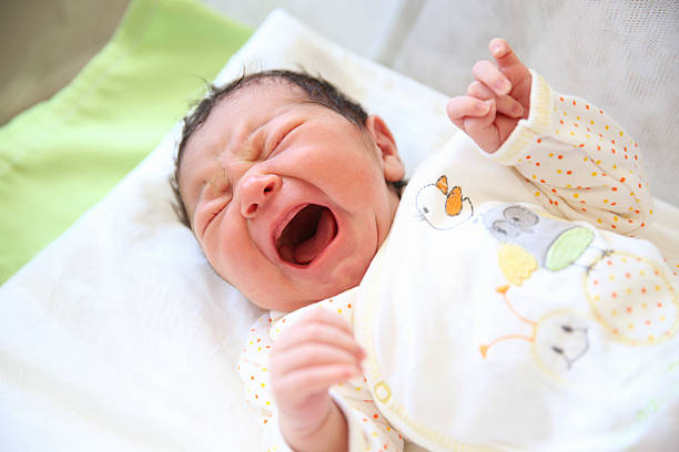 Newborn baby boy crying stock photo