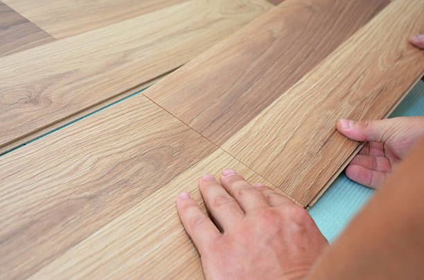 istock Installing laminate flooring fitting the next piece. Laminate flooring. 626184306