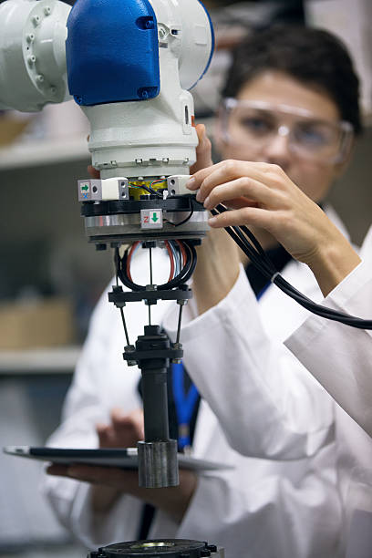 istock Engineers repairing with robotic arm 626186902