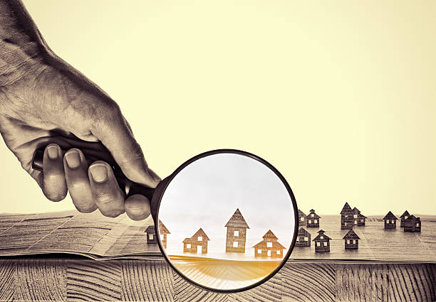 Paper house under a magnifying lens