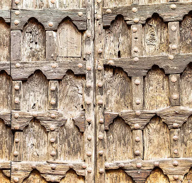 Old wooden door of an ancient church in Verona, Italy.
