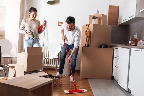 Young couple cleaning and setting new home.Moving house.