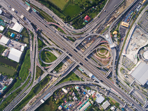 Aerial highway junction. Busy highway from aerial view. Highway shape like number 8 and infinity sign. Urban highway and lifestyle concept. Highway taken in the eastern highway of Bangkok Thailand.