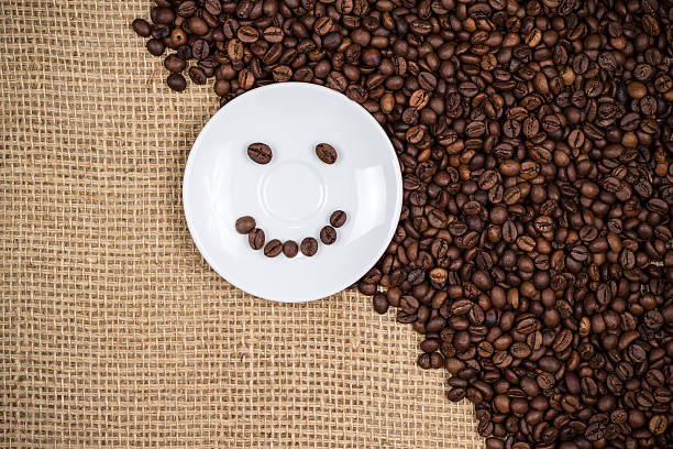 White coffeeplate with smiley coffeebeans stock photo