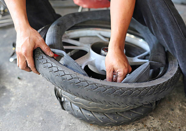 istock technician hand fixing wheel the motorcycle 626198094