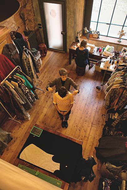 istock Seamstress and her Assistant at Working with a Customer 626204520