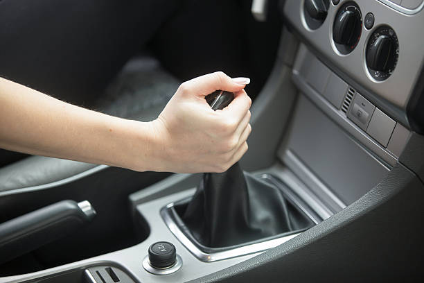 Close-up of female hand tuning vehicle audio Close-up of female hand tuning vehicle audio to provide in-car entertainment or get information, making the sound volume louder muster station stock pictures, royalty-free photos & images