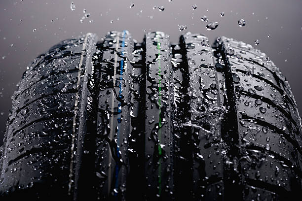 istock Water splashing on tire during the rain 626207398