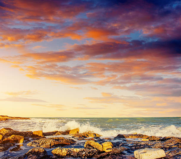 Fantastic view of the nature reserve Monte Cofano. Dramatic scene. Sunset over sea. Location cape San Vito. Sicilia, Italy, Europe. Mediterranean and Tyrrhenian sea.
