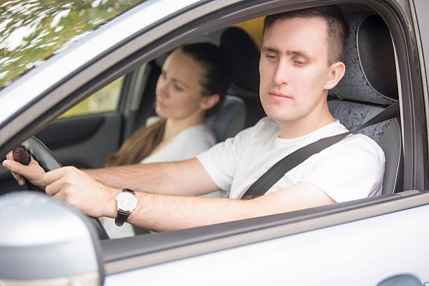 istock Young male driver looking at the side view mirrors 626213920