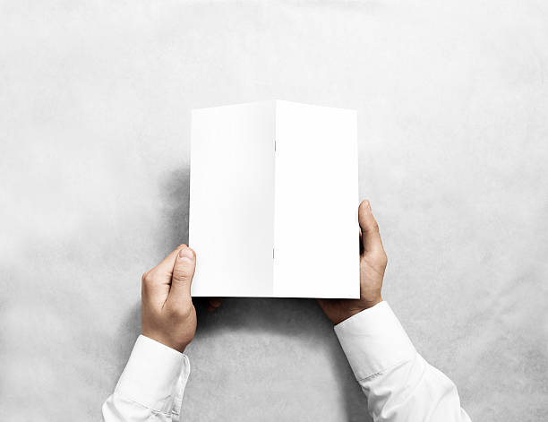istock Hand holding blank white brochure mockup, back side view. 626214150