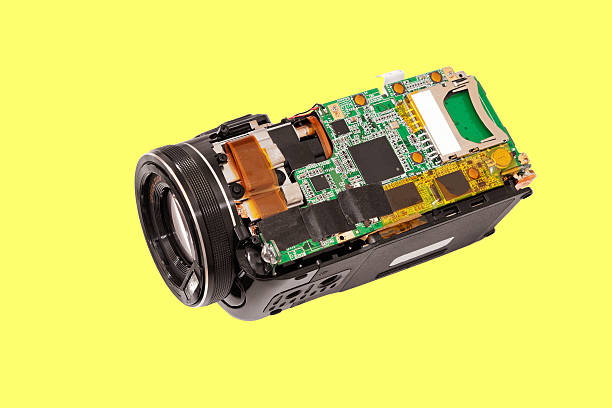 Electronic board video camera. Disassembled compact camcorder. Close-up. Isolated on a yellow background. deconstruct stock pictures, royalty-free photos & images