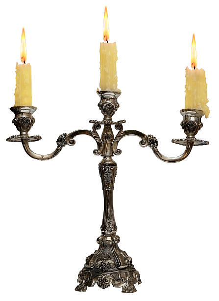 istock burning old candle vintage bronze candlestick. Isolated On White Background. 626218316