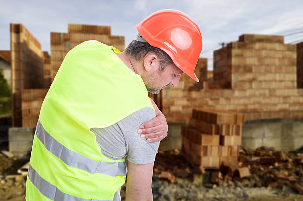 Constructor suffering from shoulder pain stock photo