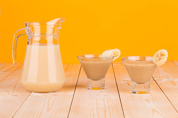istock Banana smoothie on wood table. 626231046