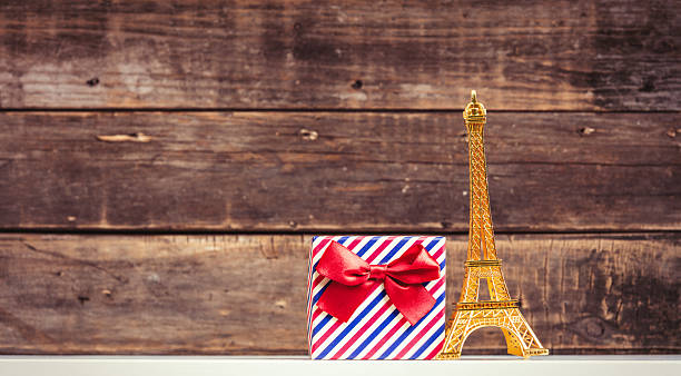 photo of the golden statue and pink gift the brown wooden background