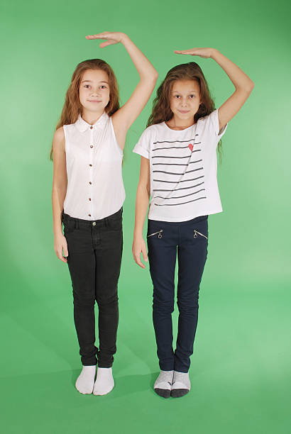 istock Girls hold hands above head and measuring his growth 626232108