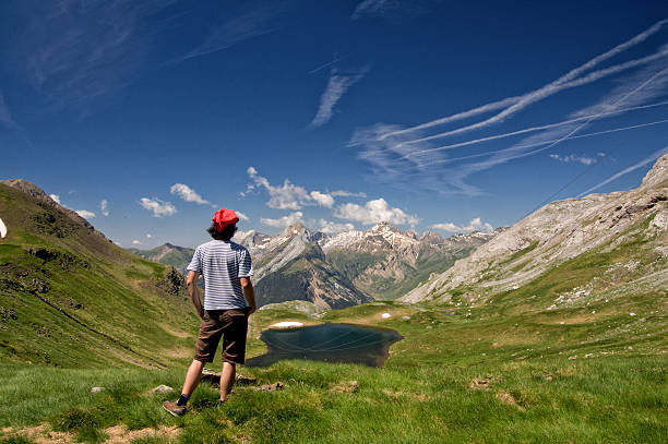 Hiker On Mountain Enjoying Nice View, Gavarnie Man on Pyrenees mountain looking at beautiful view, Gavarnie, France gavarnie stock pictures, royalty-free photos & images