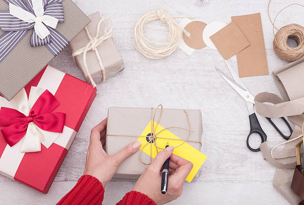 istock Woman write on christmas gift box 626233426
