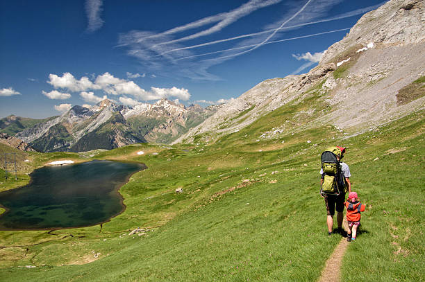 Father and his daughter hiking together on beautiful mountain Father and his little daughter hiking together on Pyrenees mountain, Gavarnie, France gavarnie stock pictures, royalty-free photos & images