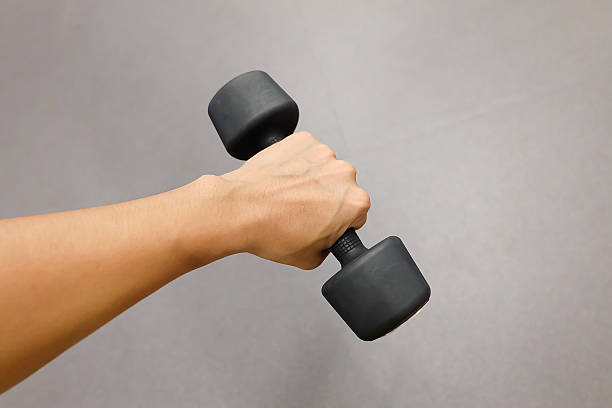 istock Hands holding dumbbells in sport club 626241104
