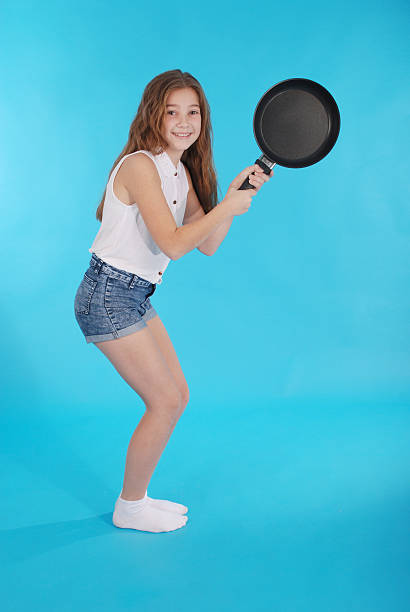 istock Young girl with a frying pan 626241294