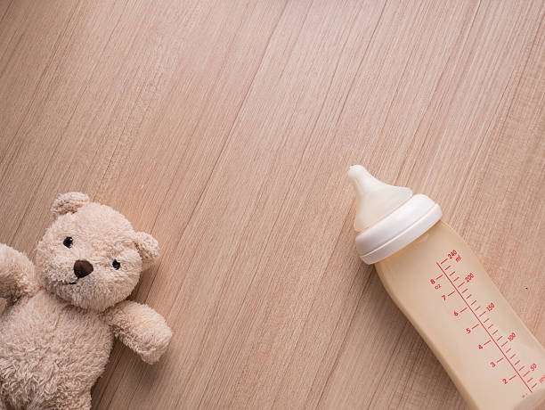 Baby bottle with milk and a measuring scale stock photo