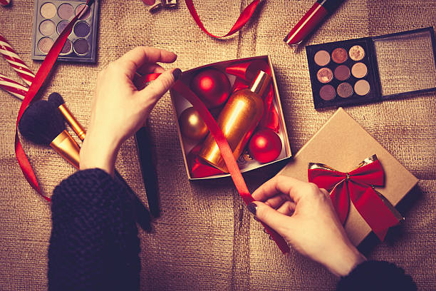 istock hands are wrapping cosmetics in christmas gifts 626242544