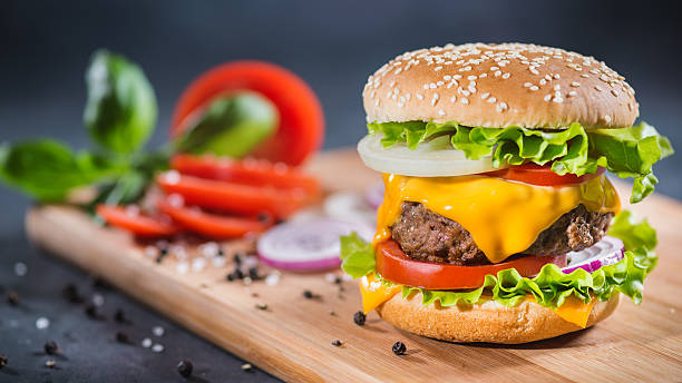 istock Home Made Huge Cheeseburger on oak chopping board 626242862