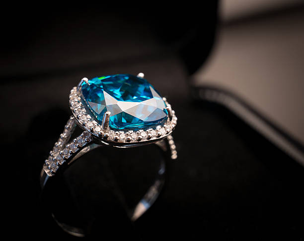 Blue topaz Jewel gemstone ring on black background stock photo