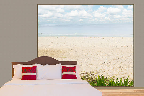 istock White bedding, pillows on the bed see through beach 626245386