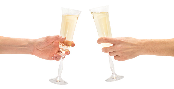 Hands holding a glass of champagne. Isolated on white
