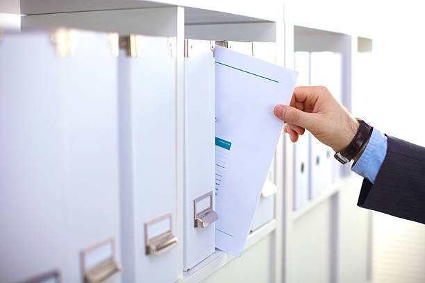 istock File folders, standing on shelves in the background 626246796
