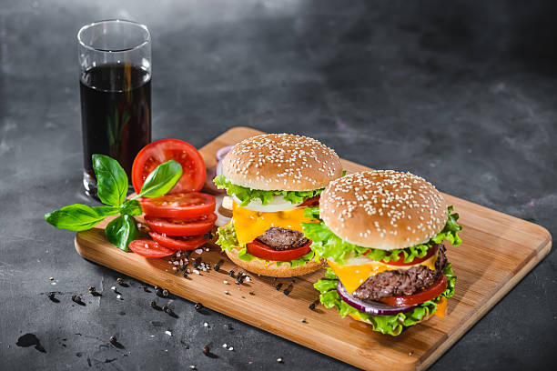 istock Two Home Made Huge Cheeseburger from above on chopping board 626247118