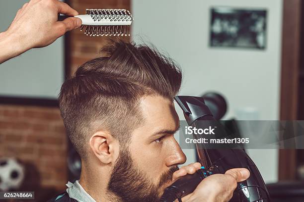 The Hands Of Young Barber Making Haircut To Attractive Man Stock Photo - Download Image Now